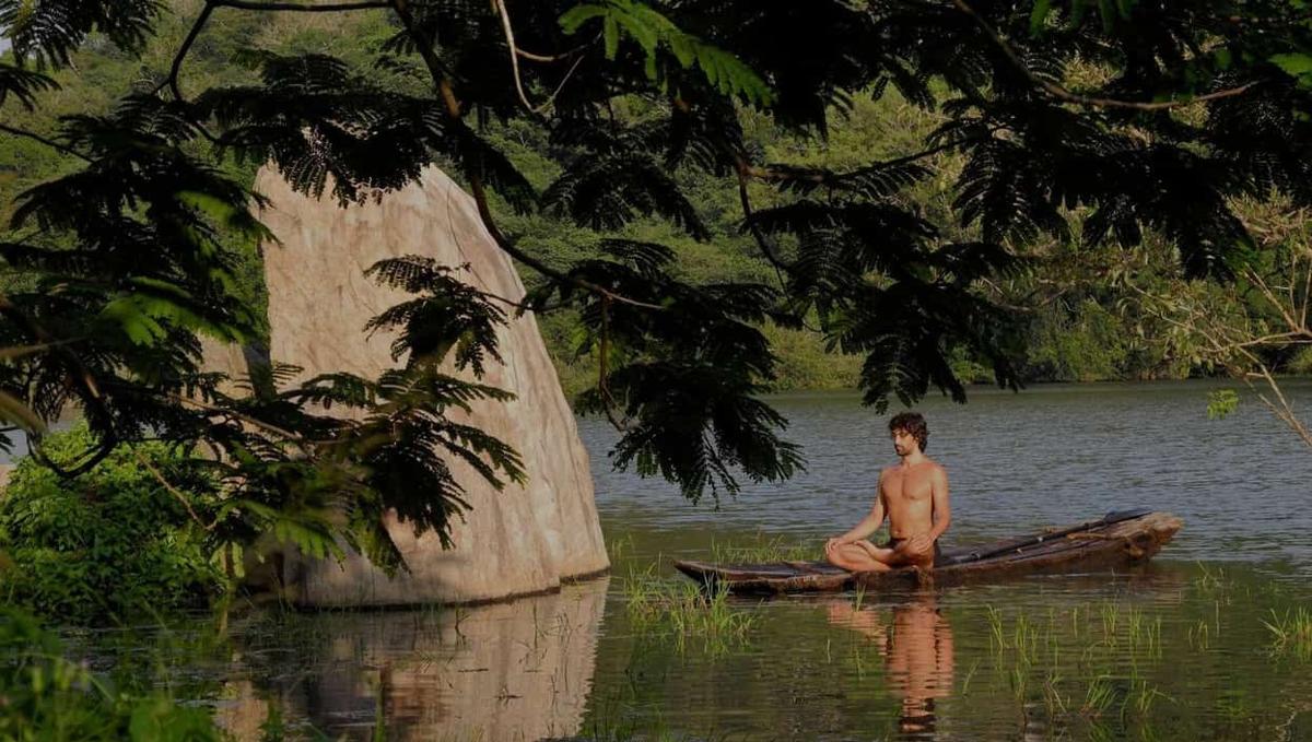 Meditation in a canoe beside a granite boulder on Ulpotha's lake.